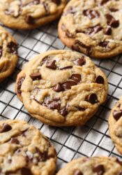 Brown Butter Chocolate Chip Cookies topped with flaked sea salt on a wire cooling rack