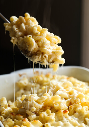 A spoonful of Midwest 5 cheese bake lifted out of a casserole dish.