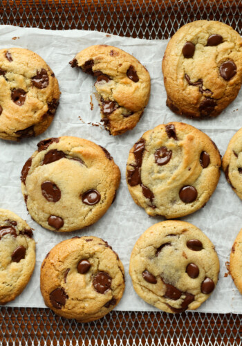 air fryer chocolate chip cookies on the air fryer rack with parchment paper