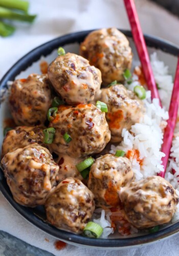 A pile of pork and beef meatballs with rice.