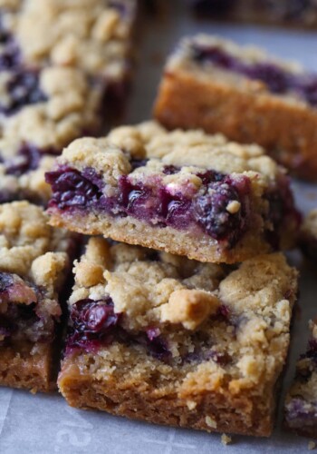 Close up of Blueberry Crumb Bars stacked on a countertop.