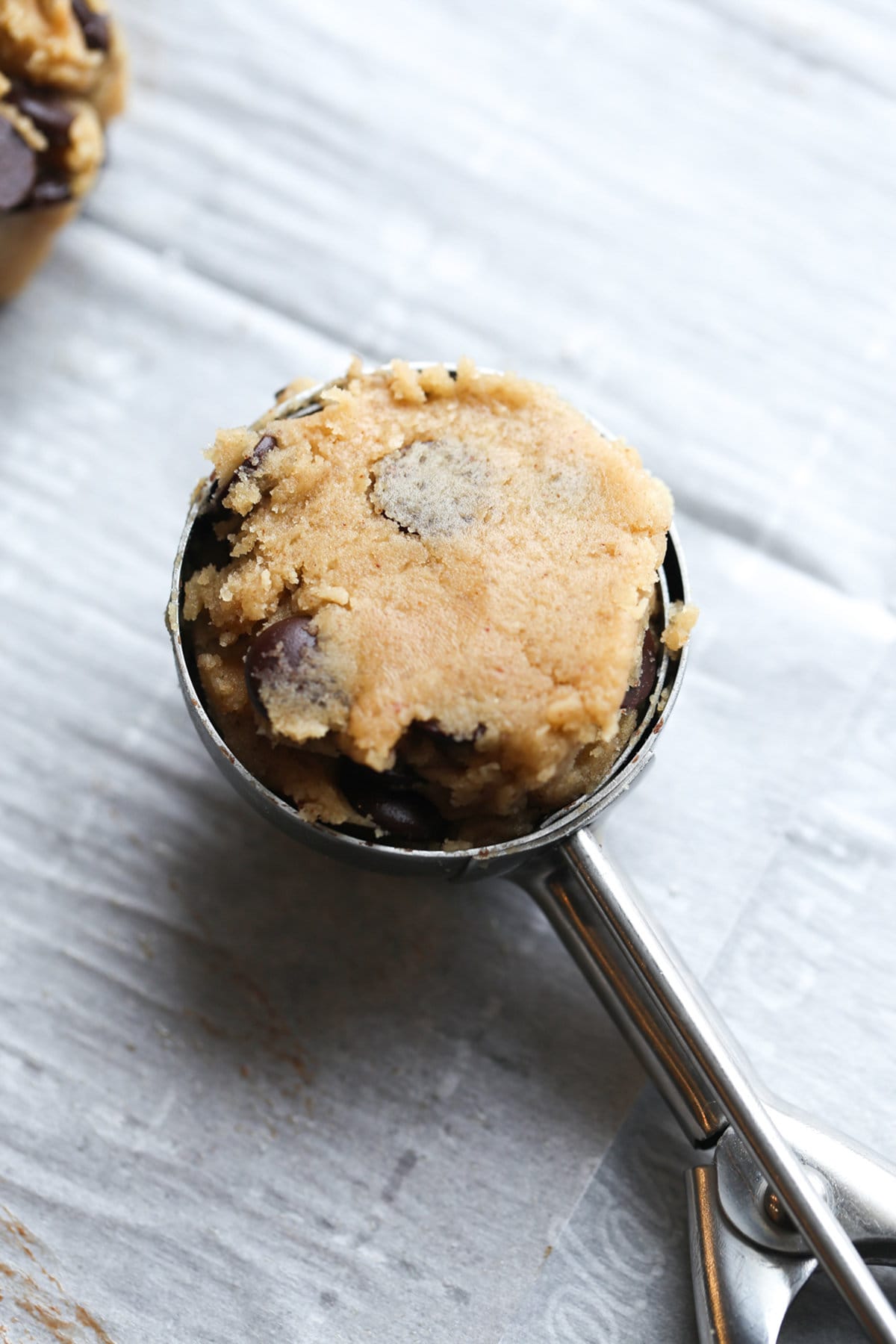 A scoop of cookie dough in a medium cookie scoop