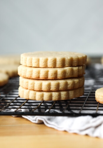 Brown sugar cut out sugar cookies stacked on a wire rack