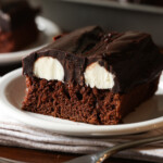 A slice of Bumpy Cake on a white plate