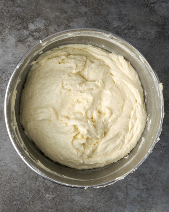 Cannoli cake batter in a metal mixing bowl.