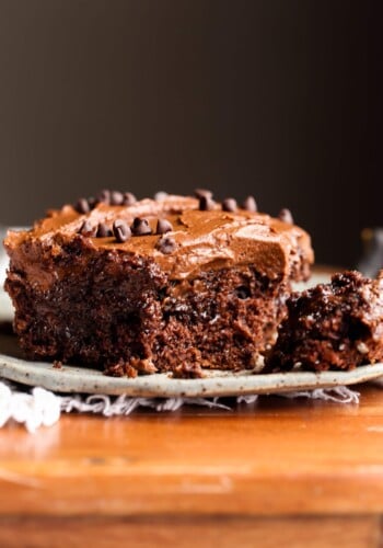 Poke Cake topped with chocolate frosting with a fork