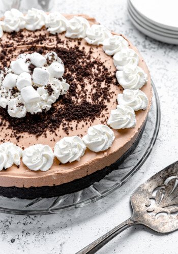 A no bake chocolate pie with whipped cream and an Oreo crust