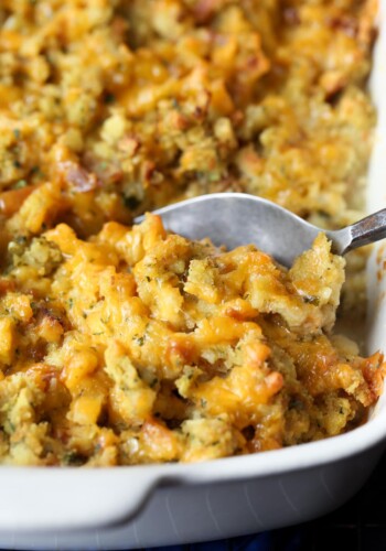 A spoon scoops Chicken Cordon Bleu Casserole from a baking dish.