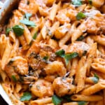 Creamy Shrimp Pasta in a large skillet with a fresh basil garnish