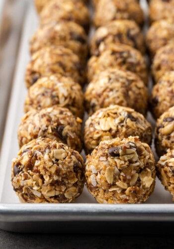 Rows of no-bake chocolate peanut butter energy bites on a baking sheet.