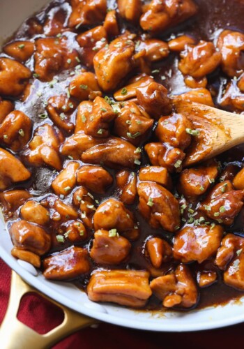 Bourbon Chicken in a skillet garnished with chives