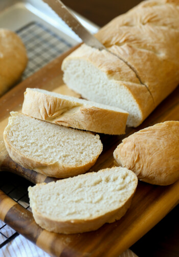 Slices of French bread on a cutting board.