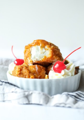 Fried ice cream with whipped cream and cherries.