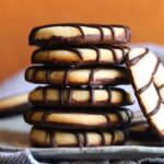 A stack of homemade fudge stripe cookies on a plate.