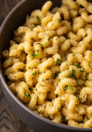 Close up of garlic bread pasta in a pot.