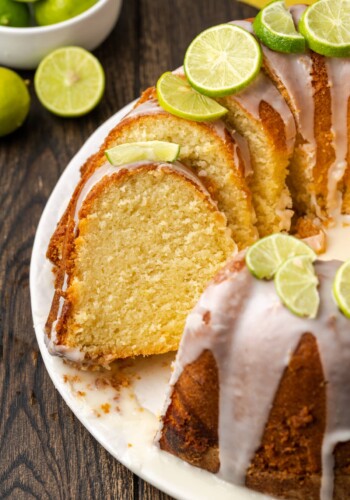 Key lime pound cake cut into slices, garnished with fresh limes.