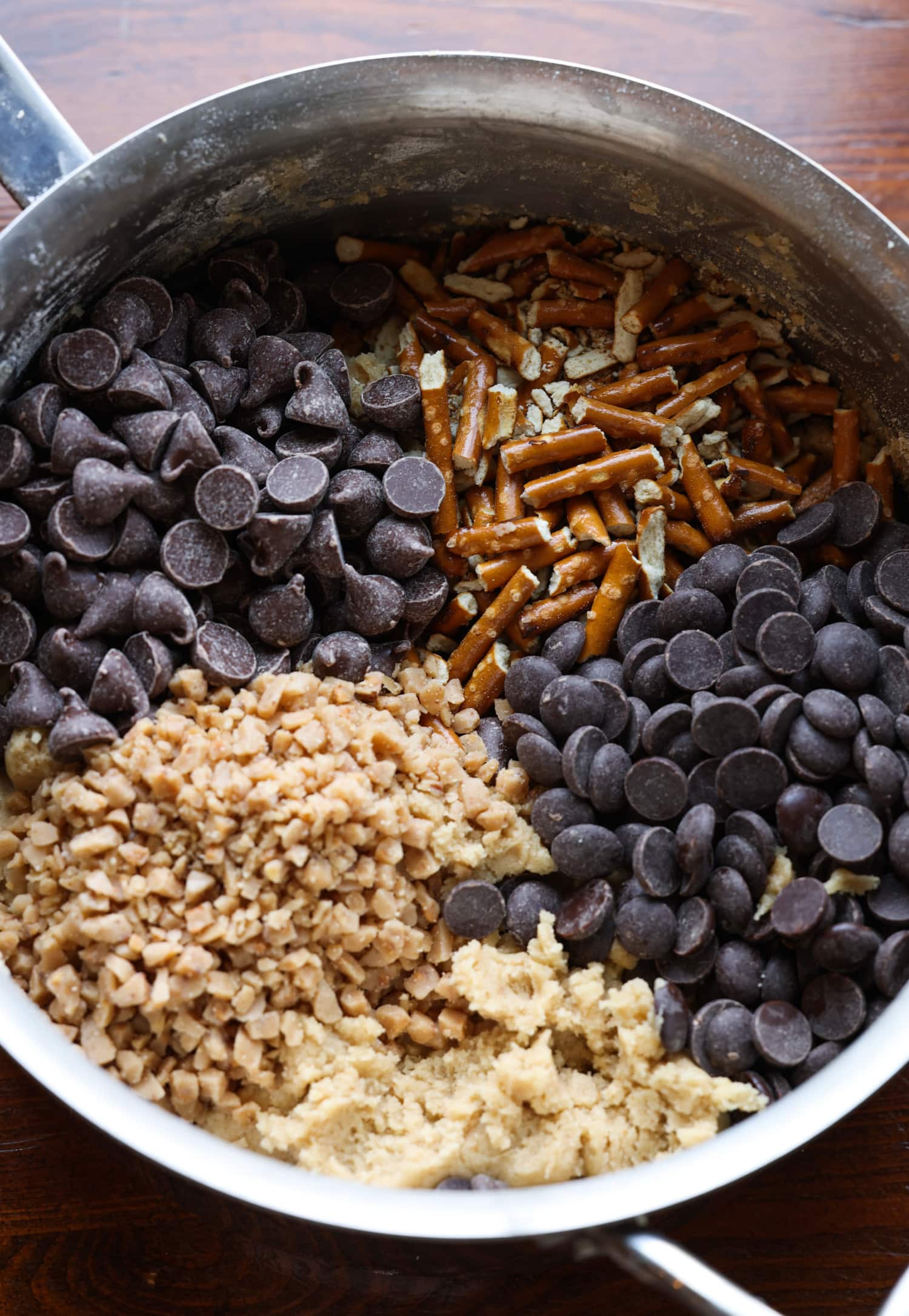 cookie dough with pretzels, chocolate chips, and toffee bits before being mixed together