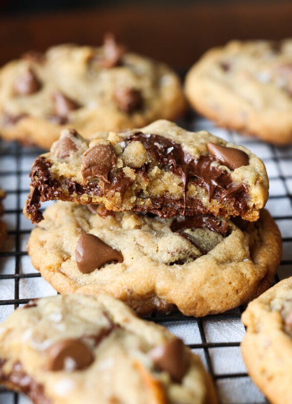 Broken cookie stacked on another with melted chocolate chips