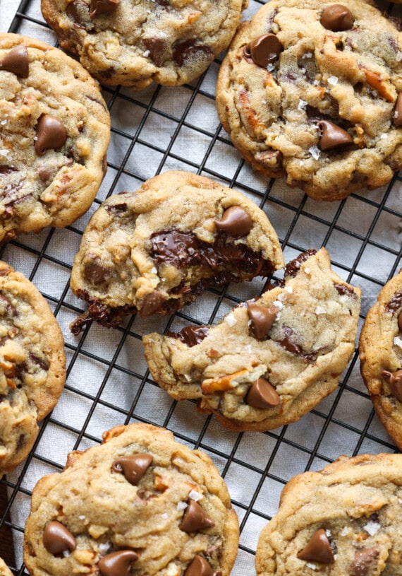 A cookie broken in half on a wire cooling rack