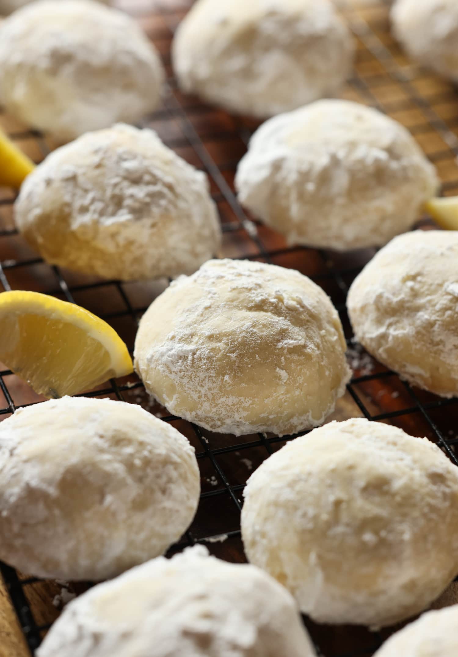 Sunshine Lemon Cooler Cookies on a cooling rack with lemon slices