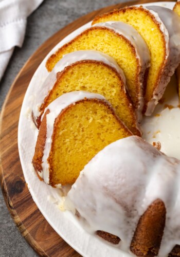 Glazed Mountain Dew bundt cake cut into slices on a plate.