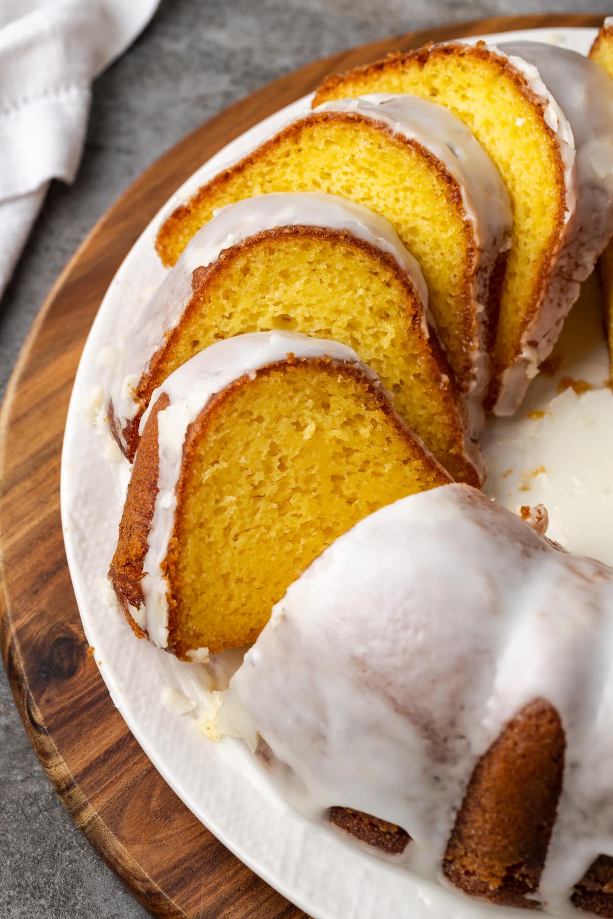 Glazed Mountain Dew bundt cake cut into slices on a plate.