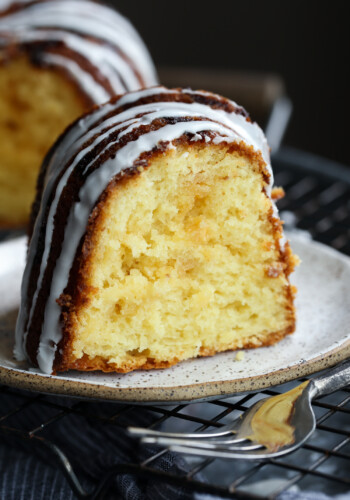 Slice of vanilla cake with vanilla icing.