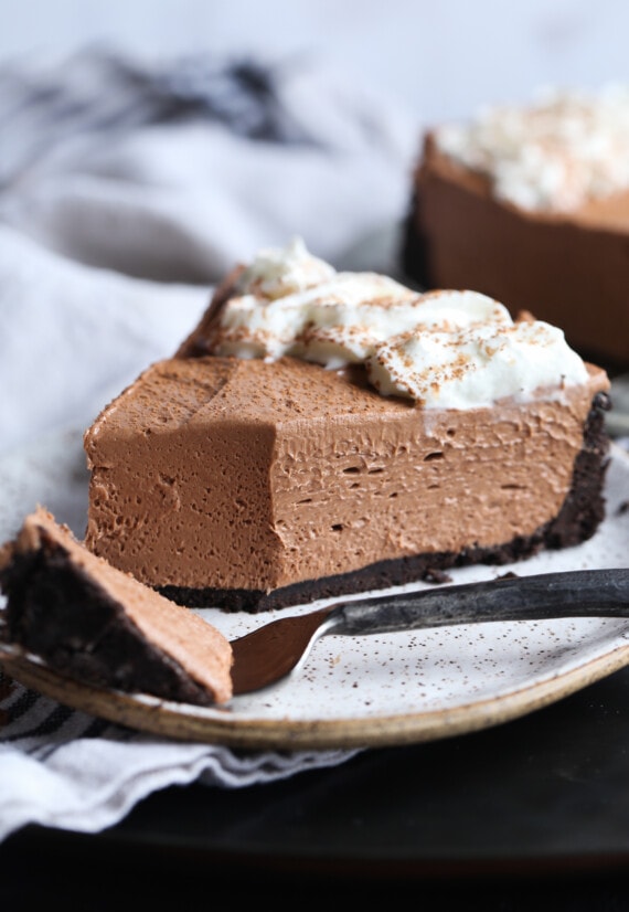 A slice of chocolate hazelnut cheesecake with a bite taken out of it.