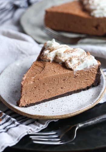 A slice of Nutella cheesecake with whipped cream.