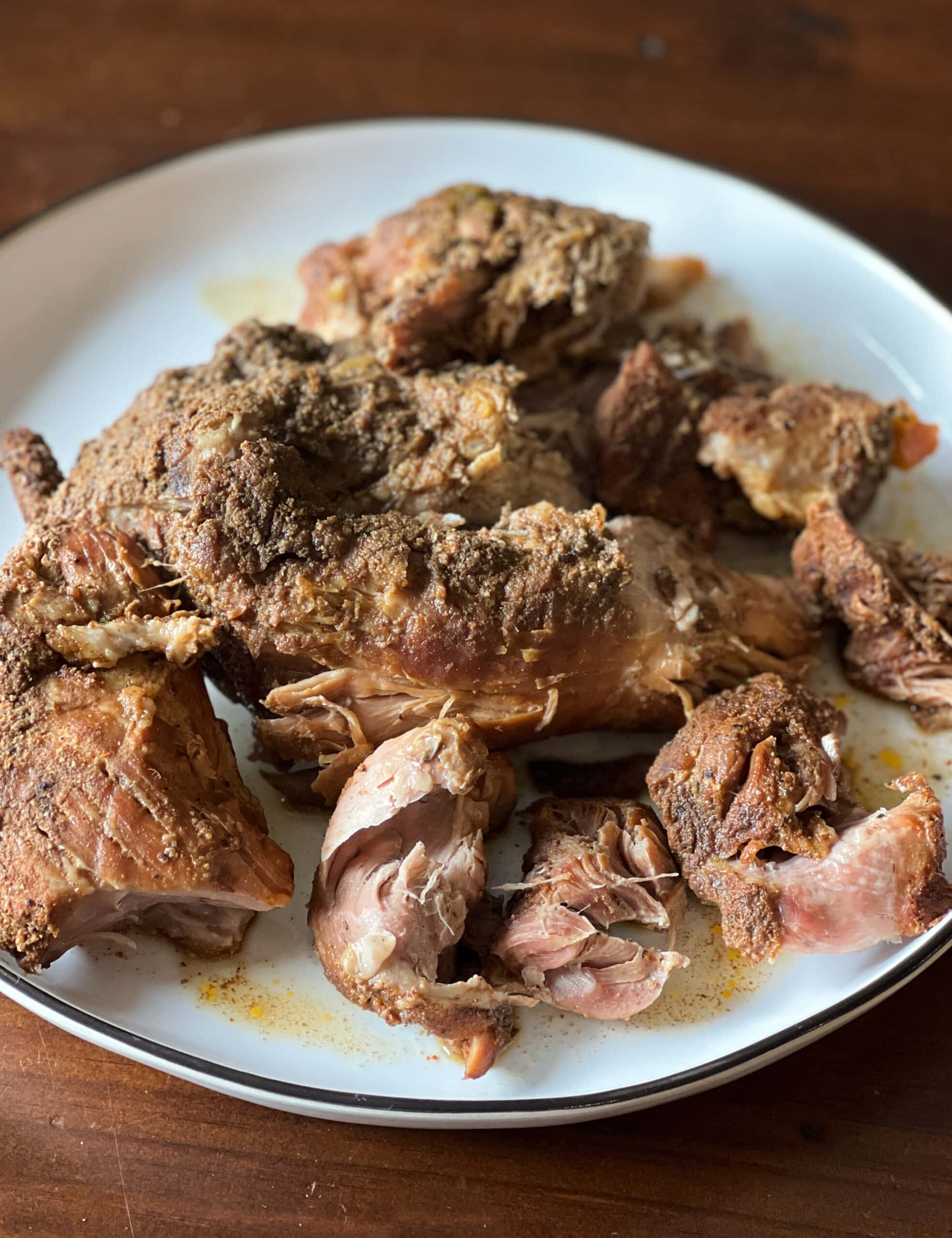 cooked pork, fork tender ready to shred on a plate