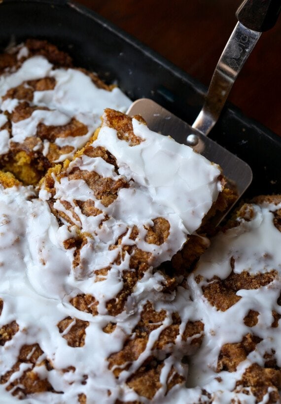 serving pumpkin cake from a sheet pan