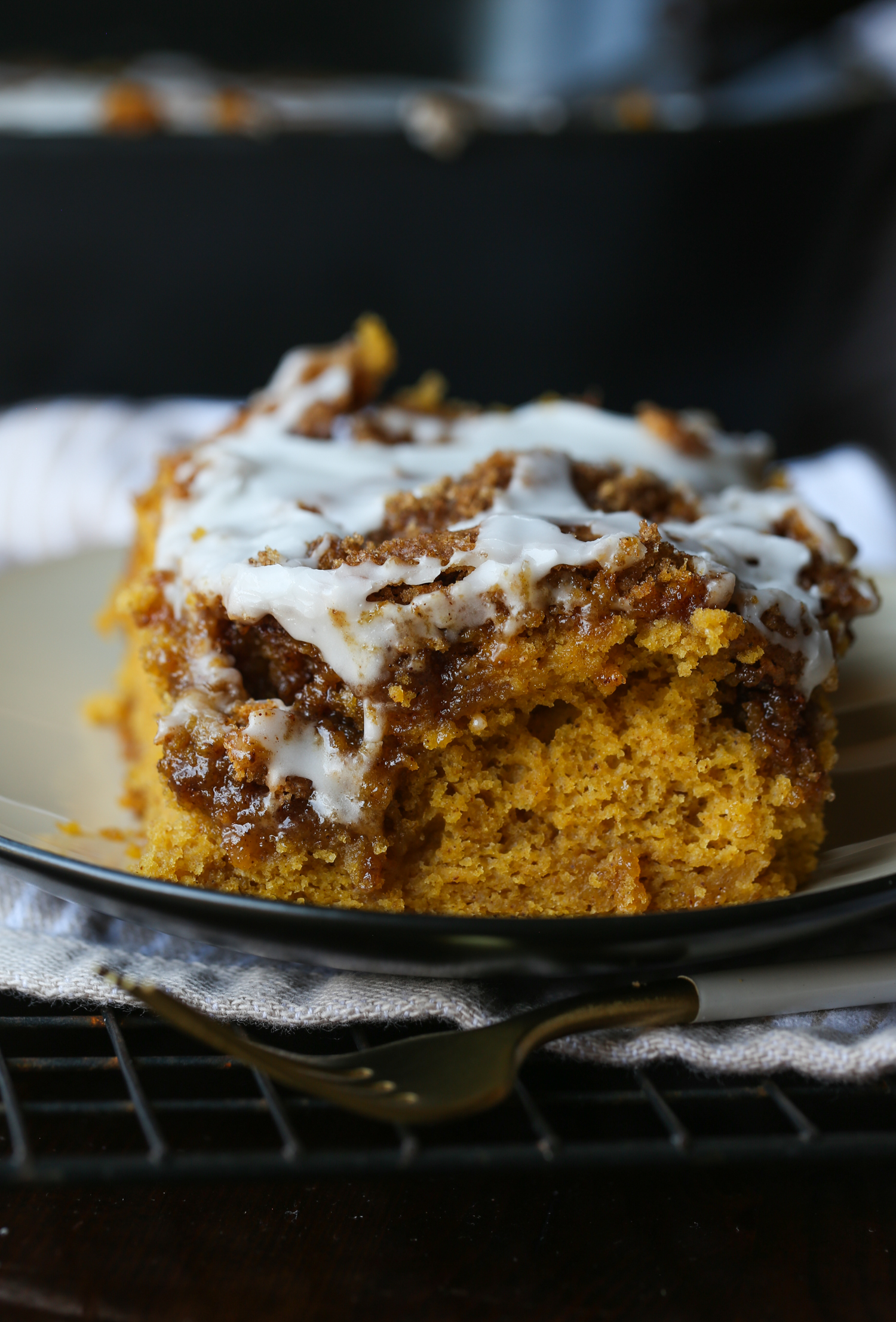 Pumpkin Cinnamon Swirl Cake on a plate with icing