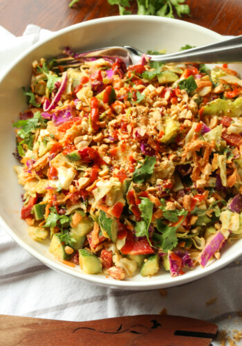 Rainbow crunch salad in a large white bowl, with a fork.