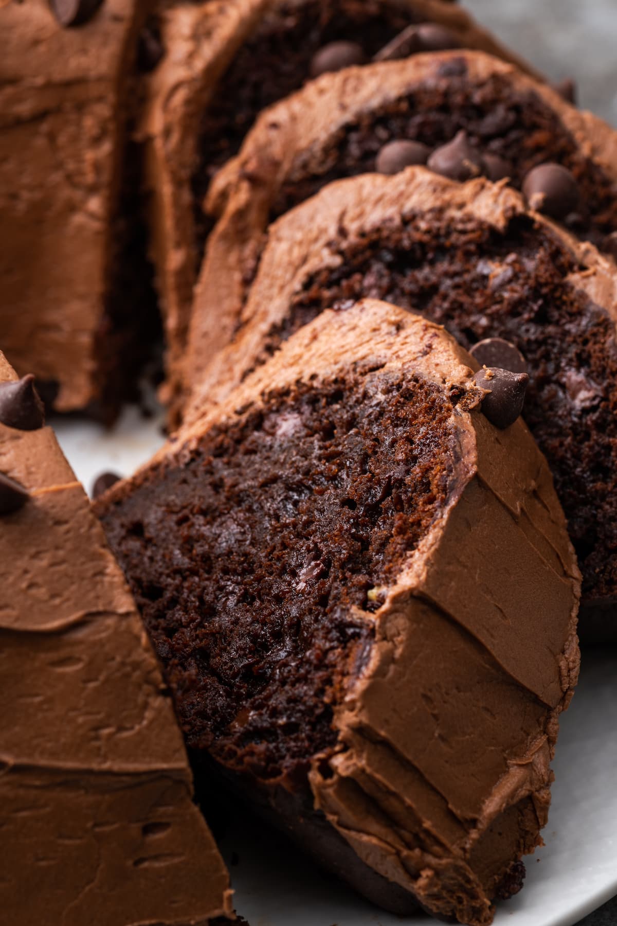 Ridiculous chocolate cake cut into slices on a plate.