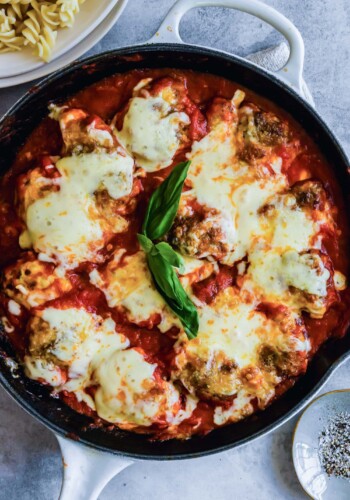 Skillet chicken parmesan with basil.