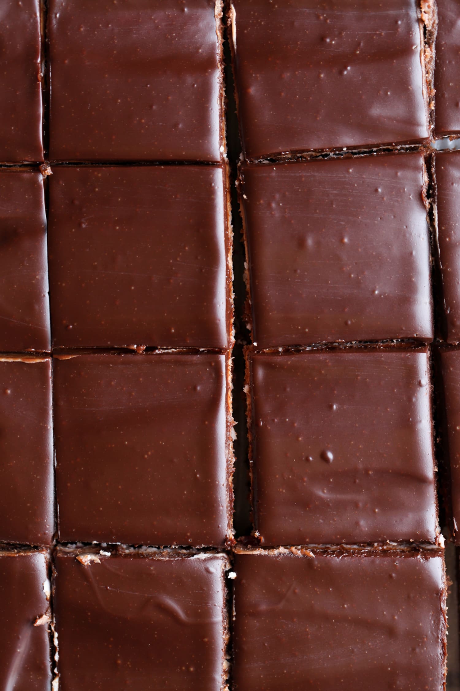 Sliced brownies topped with ganache sliced in a 9x13 baking pan shown from the top