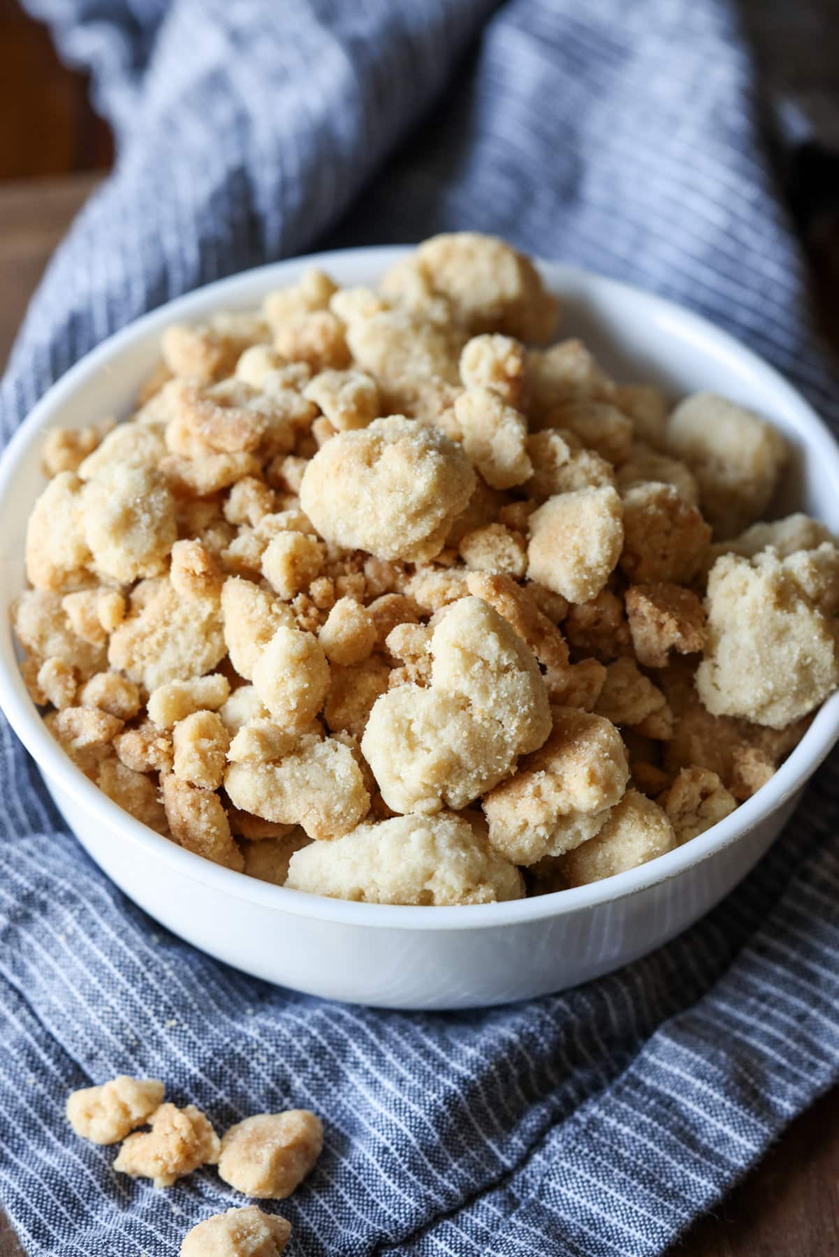 A white bowl filled with crunchy baked crumb topping