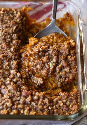 Sweet Potato Soufflé with a spoon in a casserole dish