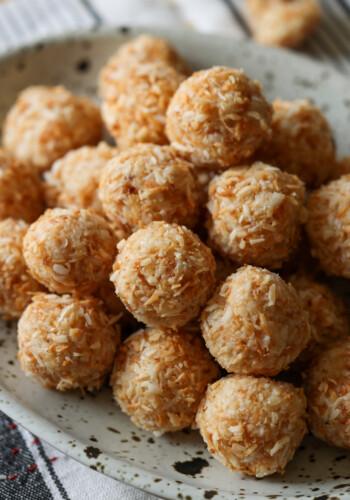 Coconut Balls rolled in toasted coconut on a platter