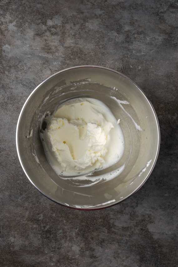 Whipped cream in a metal bowl.